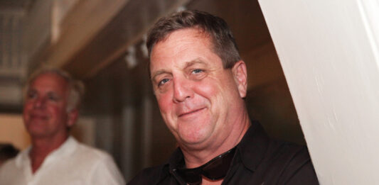 a man wearing a black shirt and a bow tie