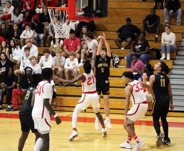 a group of young men playing a game of basketball