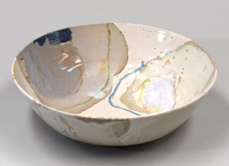 a white bowl with blue and yellow designs on it