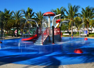 a water park with a water slide and a red slide