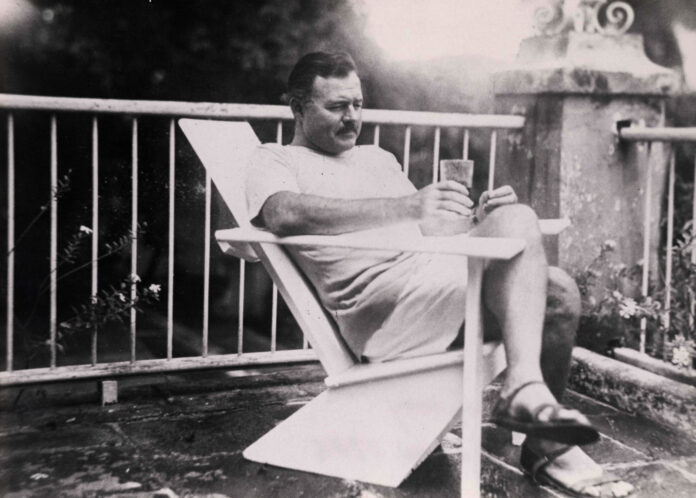 a black and white photo of a man sitting in a chair
