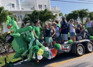 a parade float with a dragon on the back of it