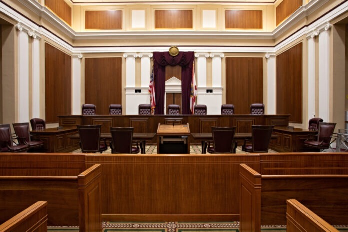 an empty courtroom with chairs and a podium