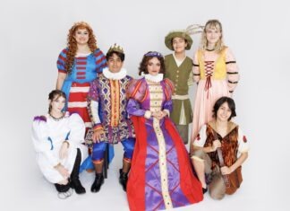 a group of people dressed in costume posing for a picture