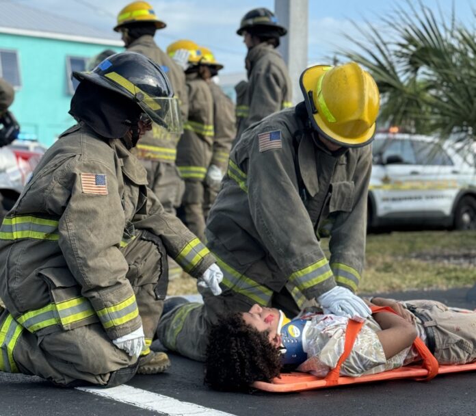 a group of firemen helping a woman on a stretcher