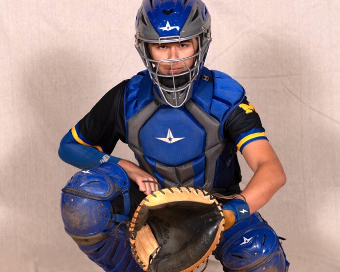 a man in a catchers outfit holding a catchers mitt