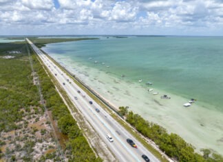 an aerial view of a highway near the ocean
