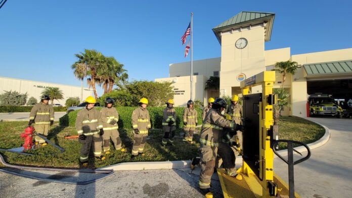 a group of firemen standing in front of a building