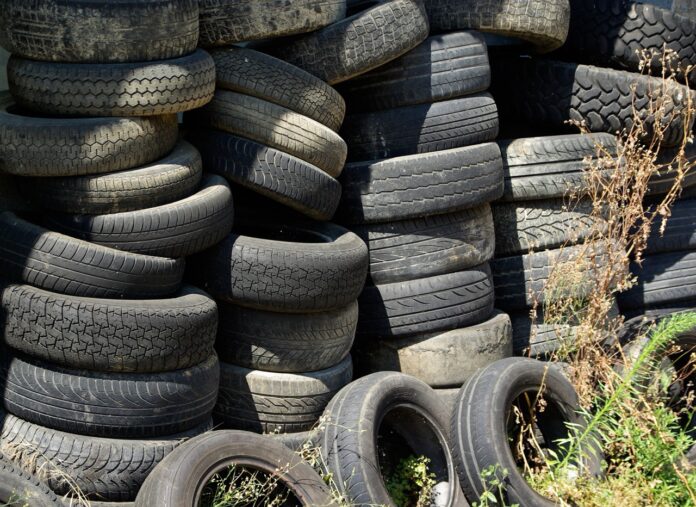 a pile of old tires stacked on top of each other