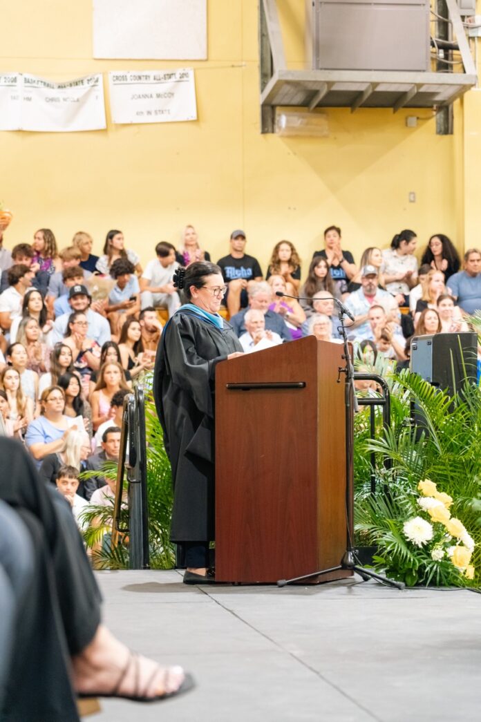 a man standing at a podium in front of a crowd