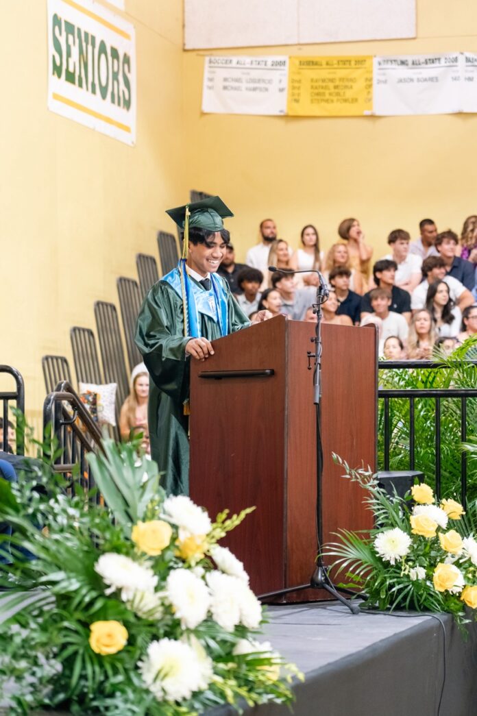 a man standing at a podium in front of a crowd