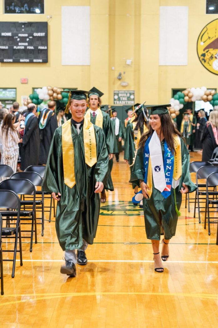 a group of people walking across a gymnasium