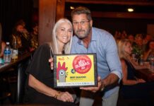 a man and woman pose for a picture in a restaurant