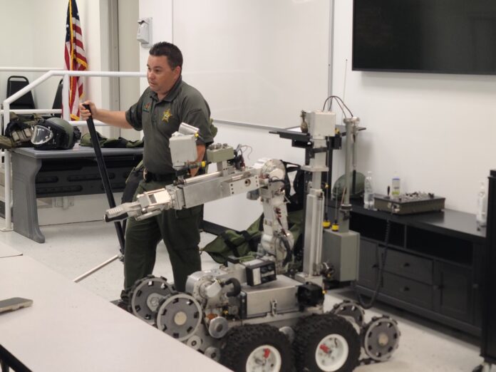a man standing next to a robot in a room
