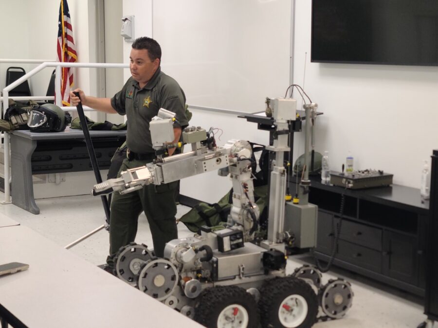 a man standing next to a robot in a room