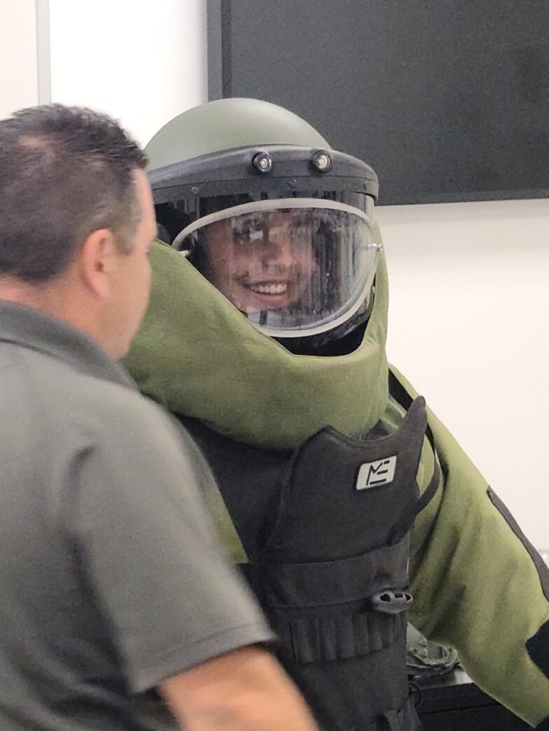 a man in a space suit is talking to another man