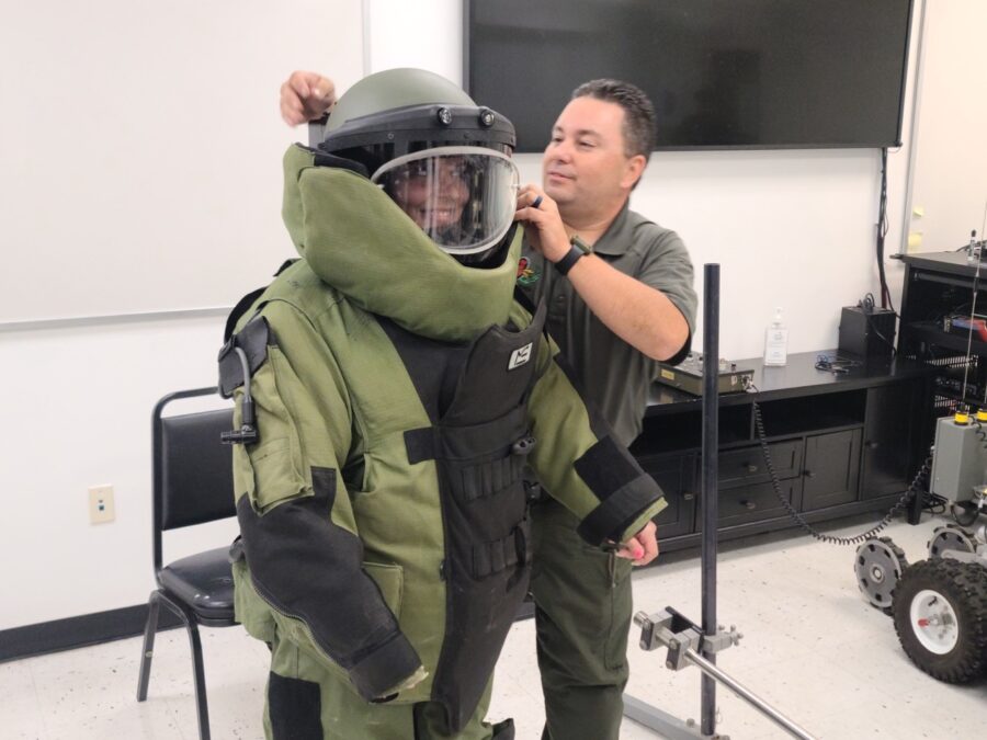 a man in a space suit putting on a helmet