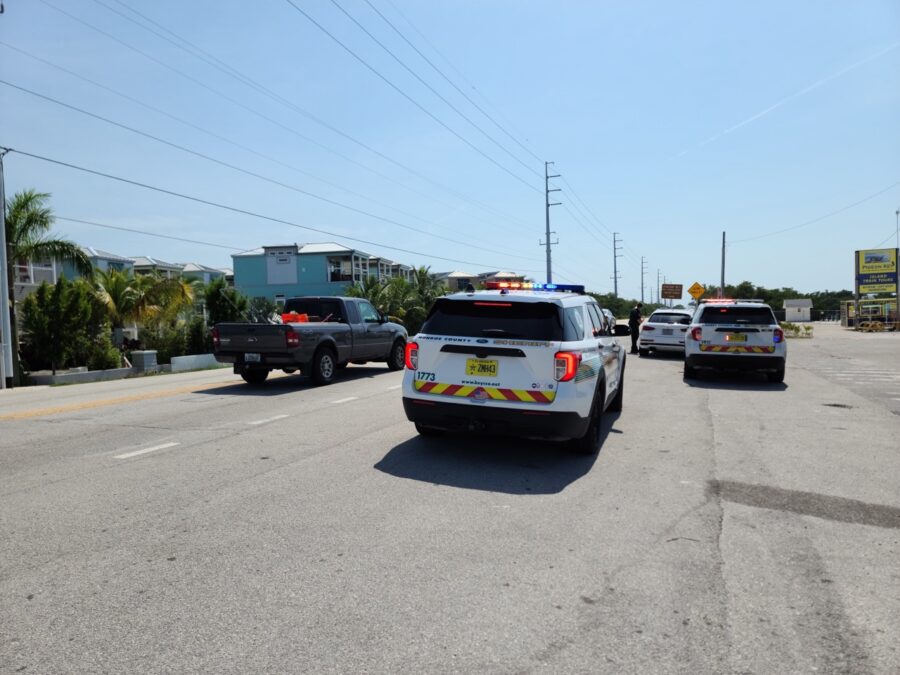 a couple of police cars driving down a street