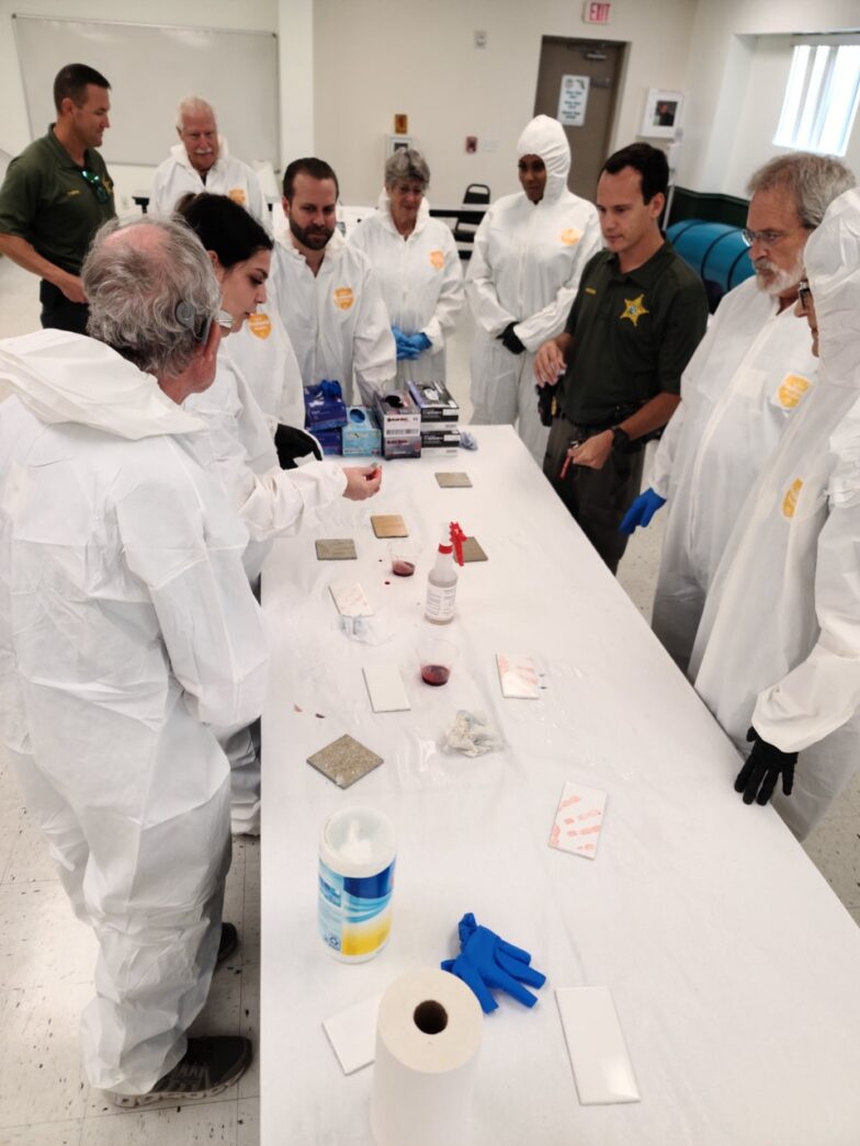 a group of people standing around a table
