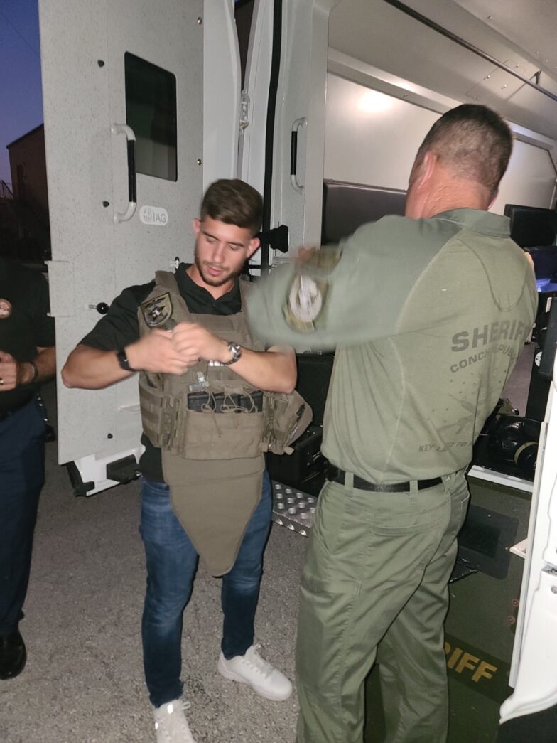 a group of men standing around each other in a room