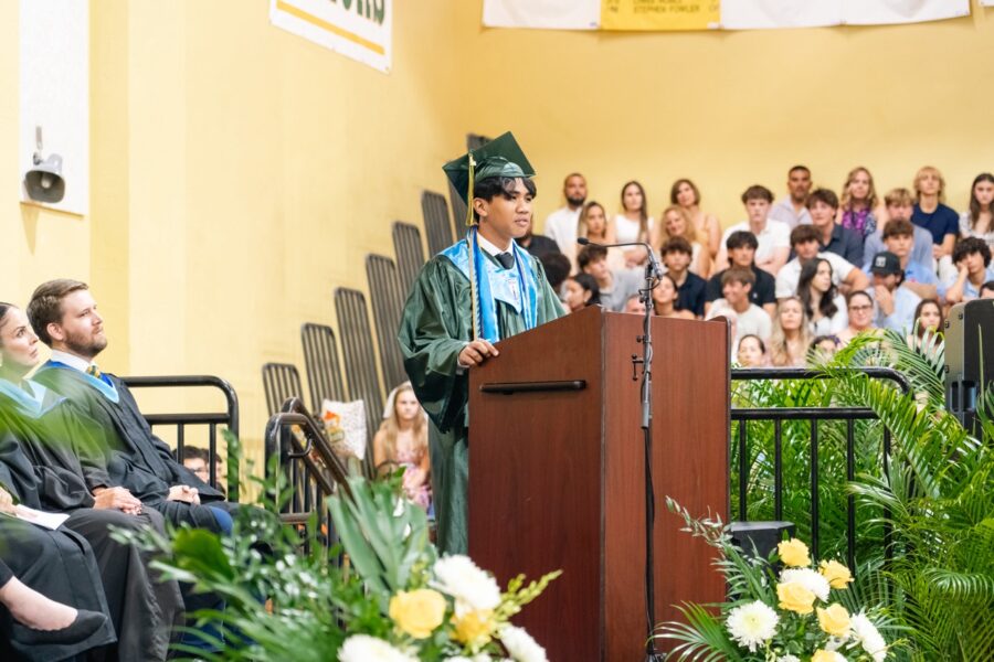 a man standing at a podium in front of a crowd