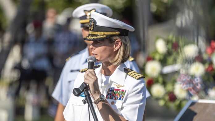 Capt Beth Regoli Memorial Day Large a woman in a military uniform speaking into a microphone