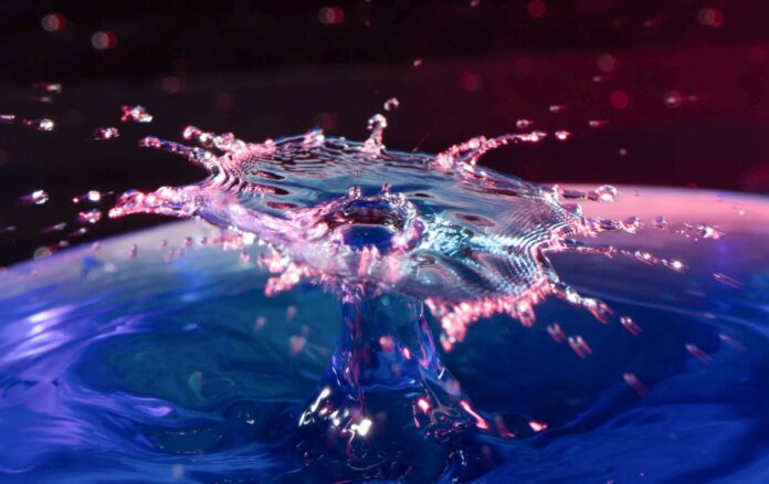 a drop of water falling into a blue bowl