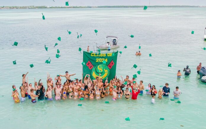 a large group of people standing in the water