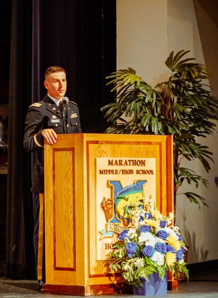 a man in a military uniform standing at a podium