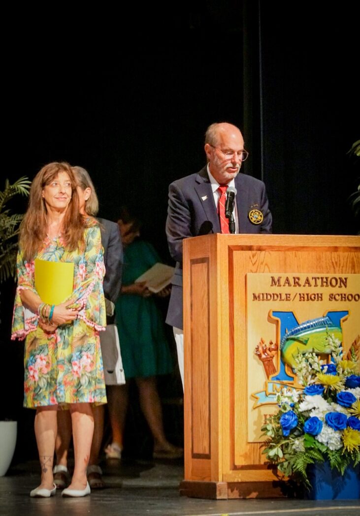 a man and a woman standing at a podium