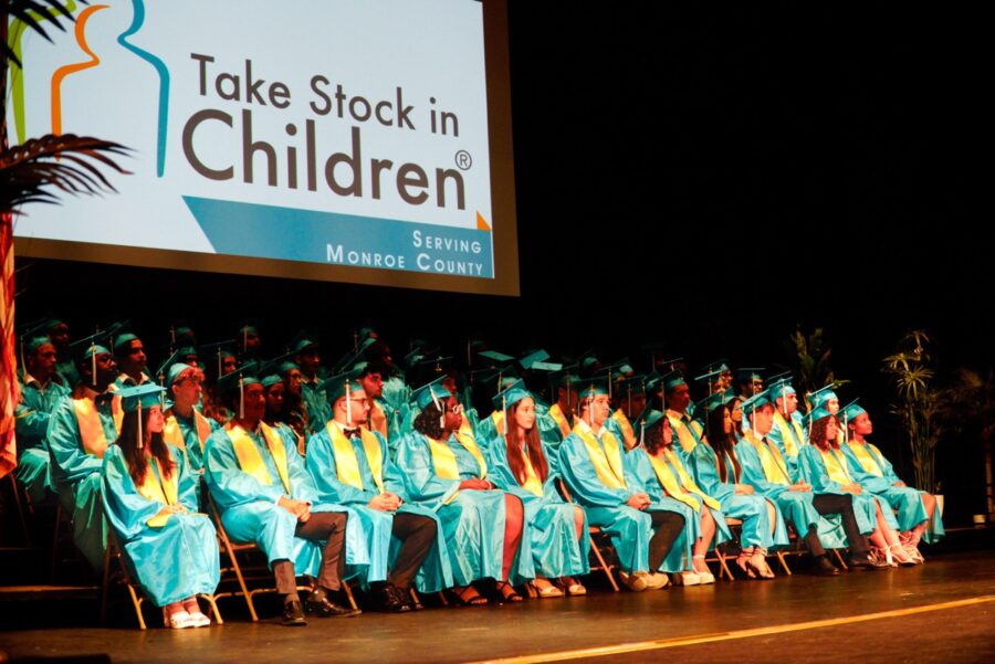 a group of graduates sitting on a stage