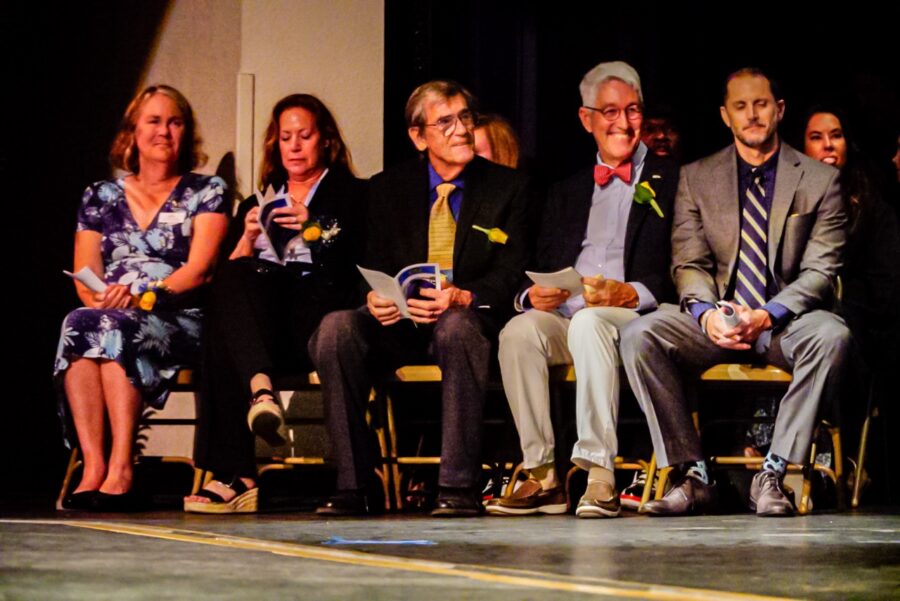 a group of people sitting on a stage