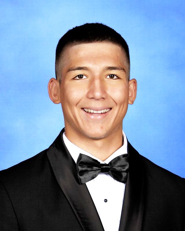 a man in a tuxedo smiling for a picture