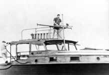 a man standing on top of a boat in the water
