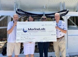 MARINELAB TEACHER INITIATIVE RECEIVES DONATION IN HONOR OF A YOUNG BOY WHO ADORED THE OCEAN a group of people standing next to each other holding a large check