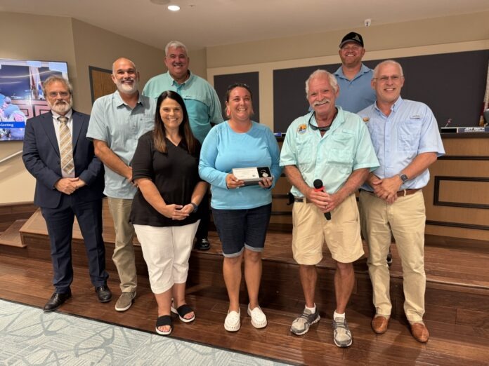 IMG_2888 a group of people standing in front of a tv