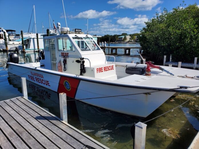 a boat docked at a dock with other boats