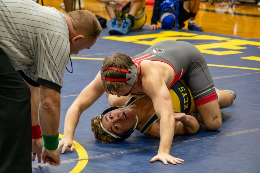 a wrestling match with a wrestler on the ground
