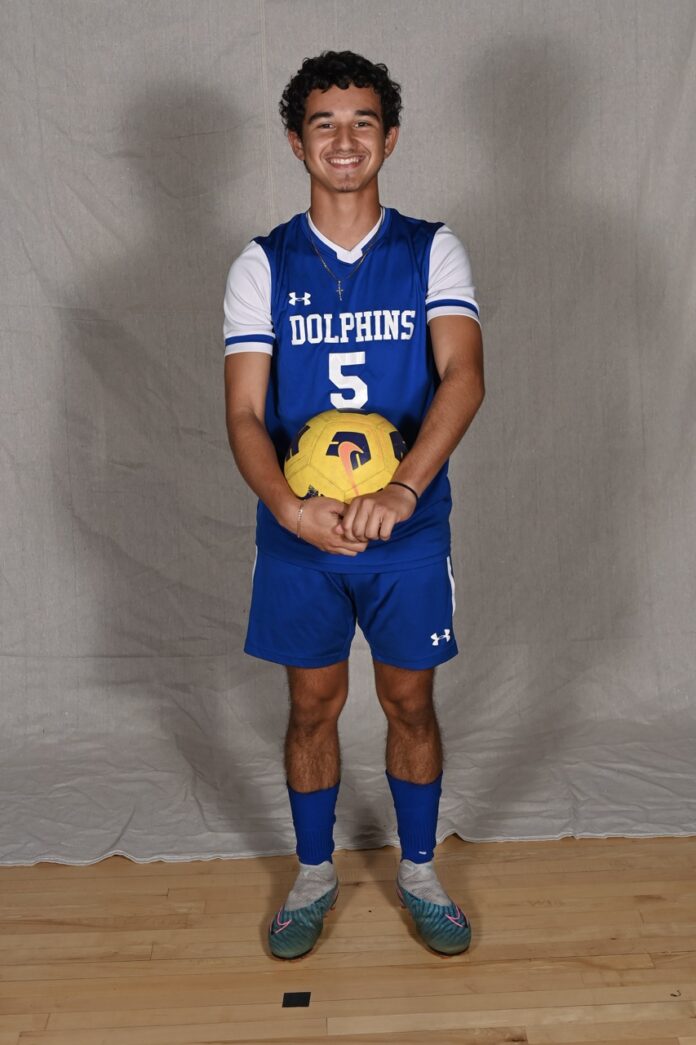 a man in a blue uniform holding a yellow ball