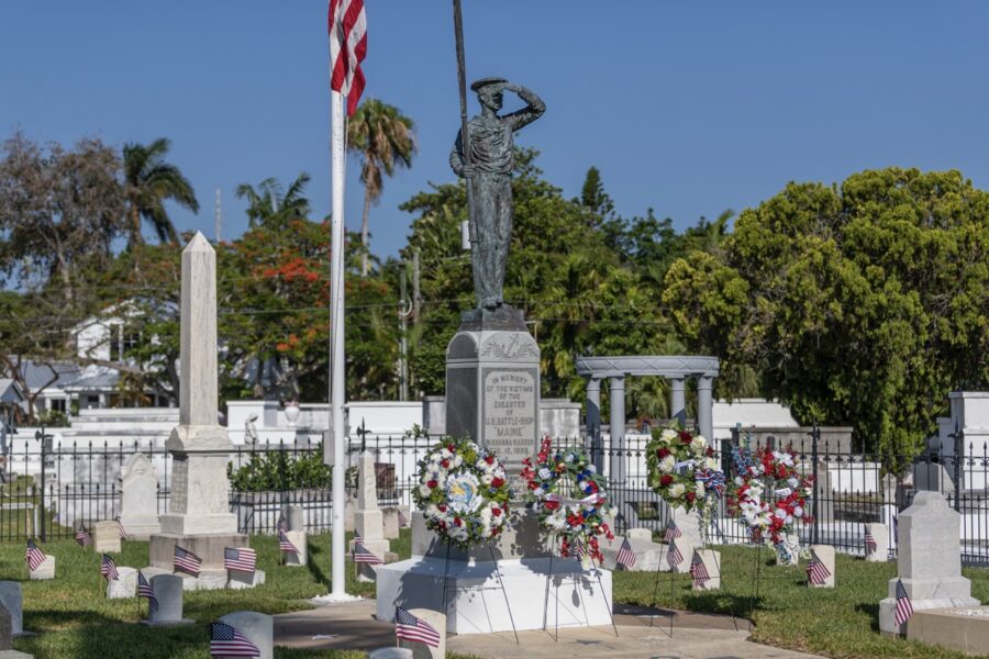 a cemetery with american flags and wreaths