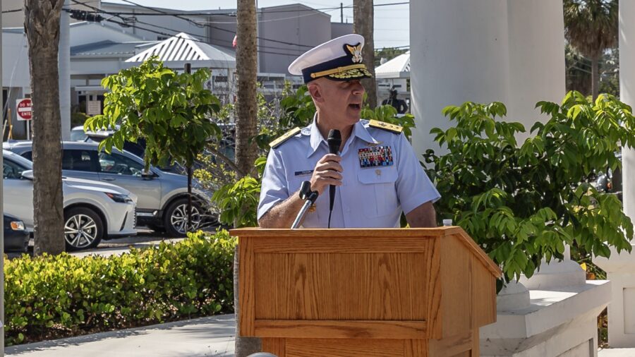 a man in a military uniform speaking at a podium