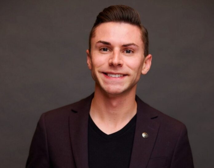a man in a suit smiling for a picture