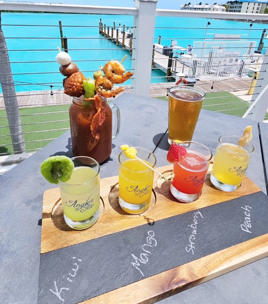 a wooden tray topped with drinks on top of a table