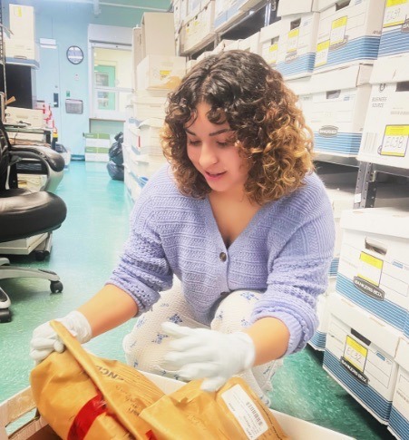 a woman in a pharmacy holding a bag