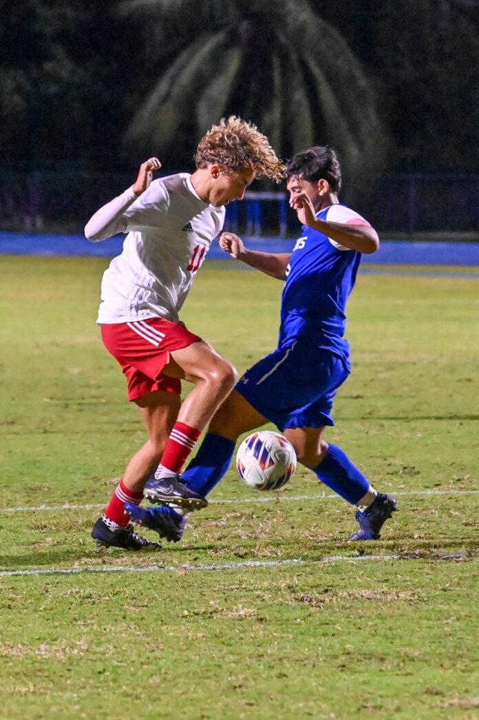 a couple of young men playing a game of soccer