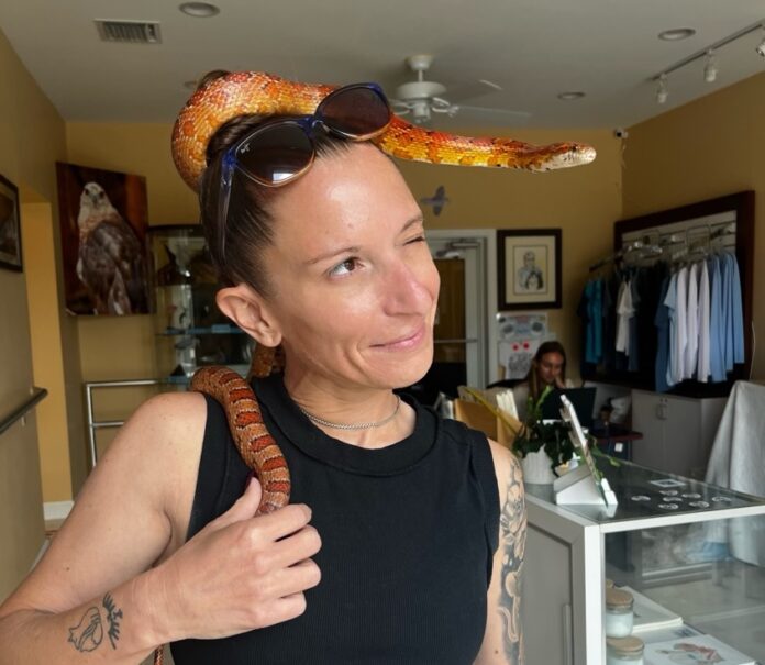 a woman with a snake on her head
