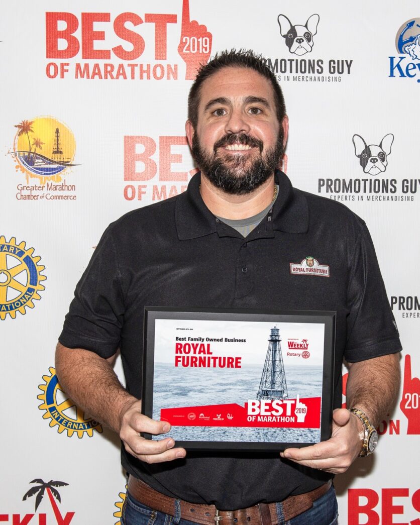 a man holding a plaque in his hands