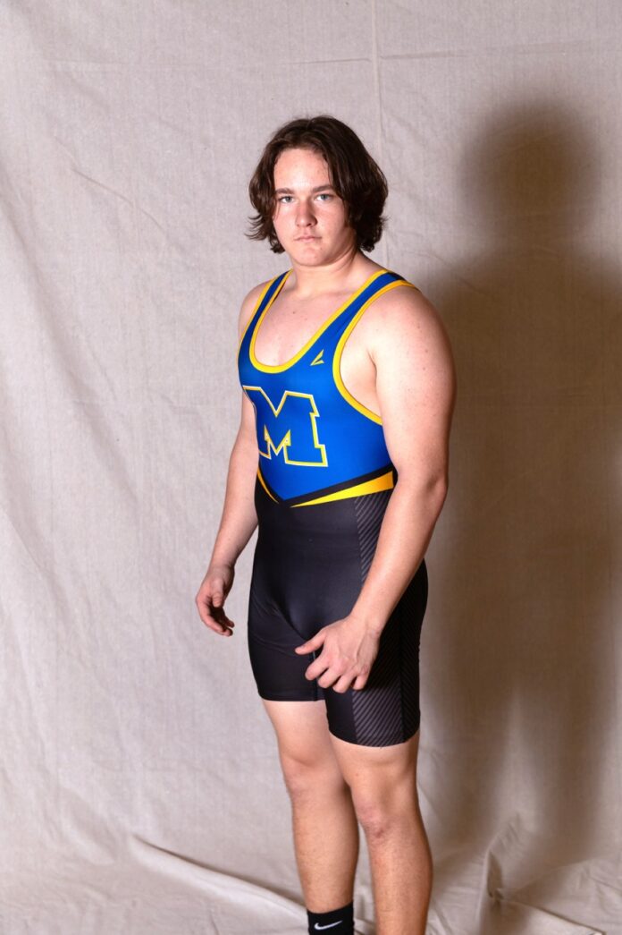 a man in a wrestling suit posing for a picture