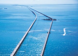 an aerial view of a long bridge in the middle of the ocean