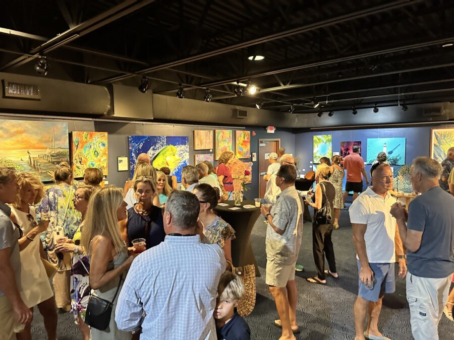 a group of people looking at art on display